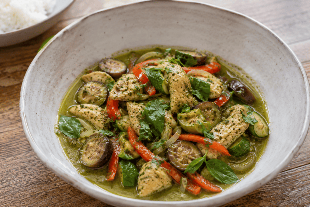 Thai green curry chicken with red pepper, baby aubergines and courgettes.