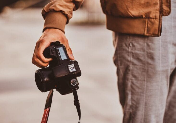 Man is carrying his digital photo camera